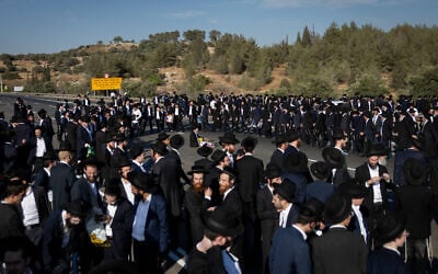 Ultra-Orthodox men block a highway between Jerusalem and Tel Aviv, on June 11, 2026. (Yonatan Sindel/Flash90)
