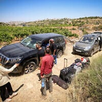 People survey damage caused to Palestinian vehicles by violent settlers who attacked a group of Palestinians and Jewish activists near Halhul, in the Hebron area of the West Bank, on June 15, 2026. (Wisam Hashlamoun/Flash90)