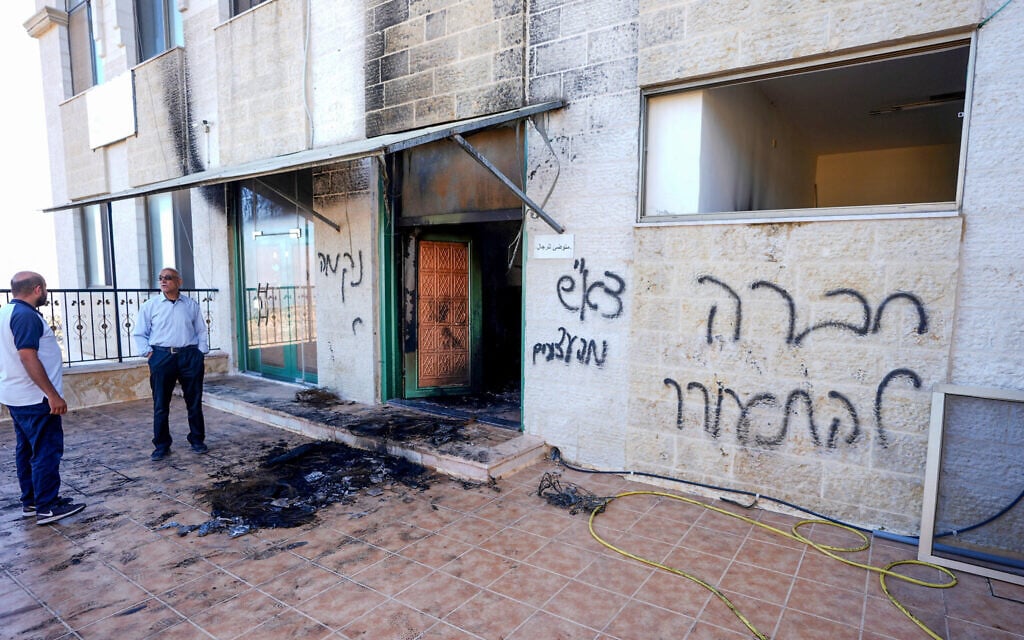 Palestinians inspect damage at the entrance to a mosque in Jaljilia near Ramallah in the West Bank, after it was reportedly set on fire by settlers, June 17, 2026 (Flash 90)