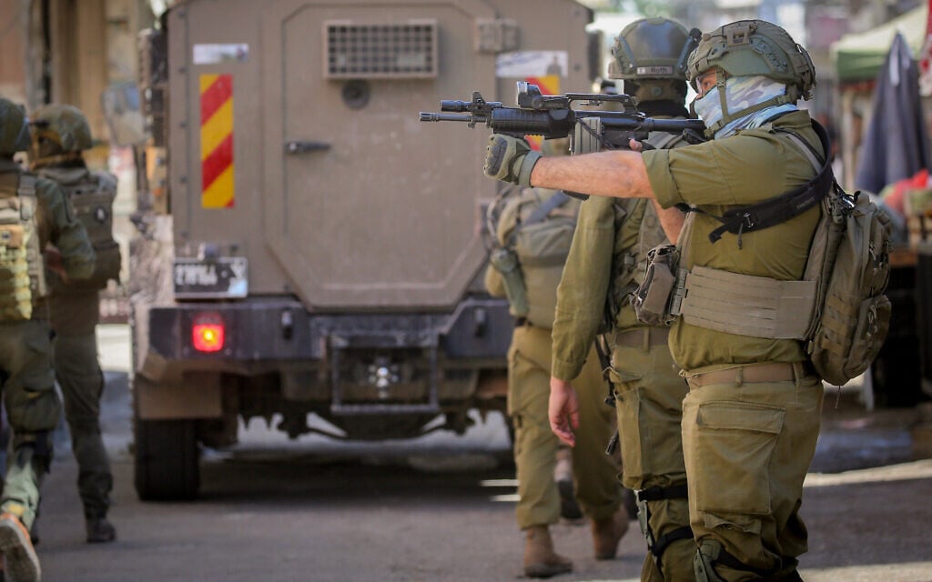 IDF soldiers are positioned in the middle of the market during a raid on Balata refugee camp east of Nablus in the West Bank, June 18, 2026. (Nasser Ishtayeh/Flash90)