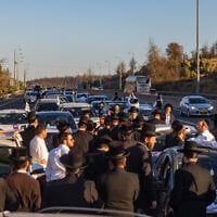 Ultra-Orthodox demonstrators block Route 1 near Jerusalem during a protest against the imprisonment of yeshiva students who failed to comply with military recruitment orders, June 24, 2026. (Chaim Goldberg/Flash90)