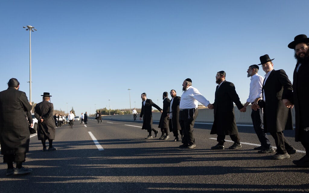 Ultra-Orthodox Jewish men block Route 1 outside of Jerusalem during a protest against military conscription, June 24, 2026. (Yonatan Sindel/Flash90)