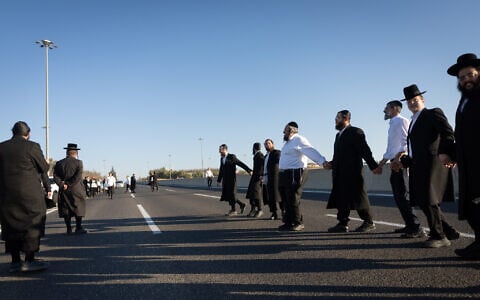 Ultra-Orthodox Jewish men block Route 1 outside of Jerusalem during a protest against military conscription, June 24, 2026. (Yonatan Sindel/Flash90)