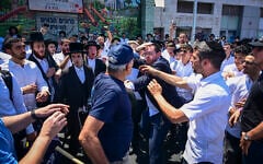Protesters supporting the conscription of ultra-Orthodox men into the military block a road in the Haredi city of Bnei Brak, central Israel, clashing with locals, on June 26, 2026. (Avshalom Sassoni/Flash90)