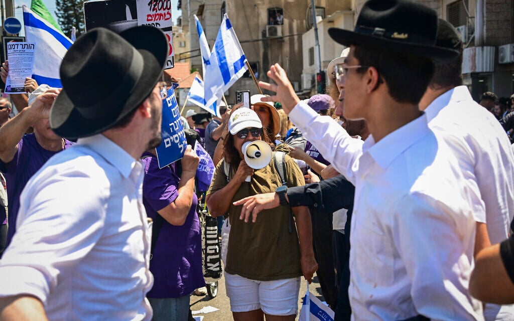 Protesters supporting the conscription of ultra-Orthodox men into the military block a road in the Haredi city of Bnei Brak, central Israel, clashing with locals, on June 26, 2026. (Avshalom Sassoni/Flash90)