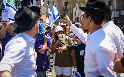 Protesters supporting the conscription of ultra-Orthodox men into the military block a road in the Haredi city of Bnei Brak, central Israel, clashing with locals, on June 26, 2026. (Avshalom Sassoni/Flash90) Protesters supporting the conscription of ultra-Orthodox men into the military block a road in the Haredi city of Bnei Brak, central Israel, clashing with locals, on June 26, 2026. (Avshalom Sassoni/Flash90)
