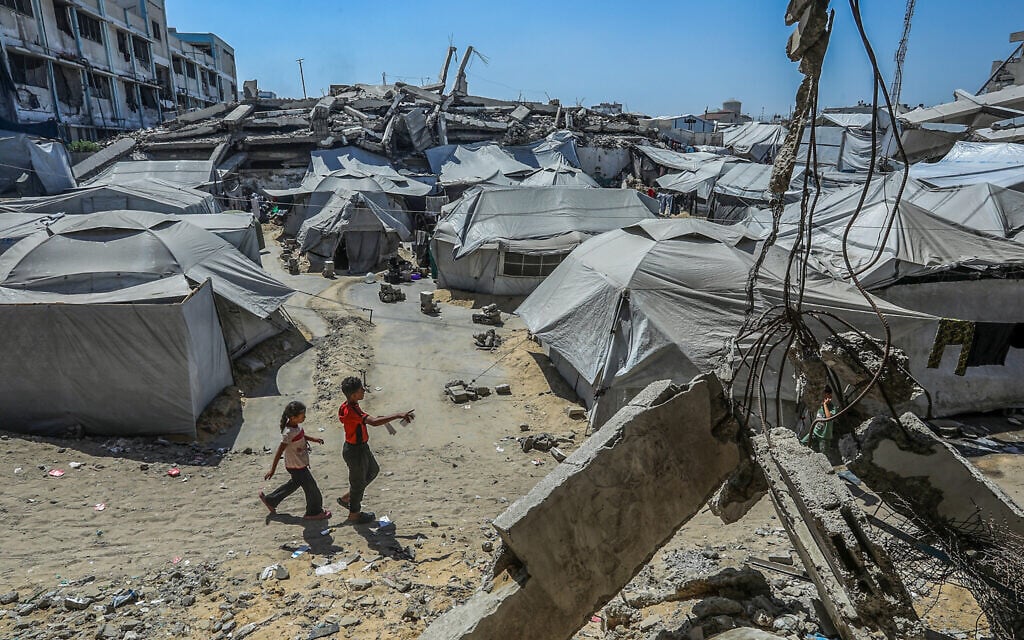 Palestinians who lost their homes in the recent war are seen near their tents in Khan Younis, in the southern Gaza Strip, June 28, 2026. (Abed Rahim Khatib/Flash90)