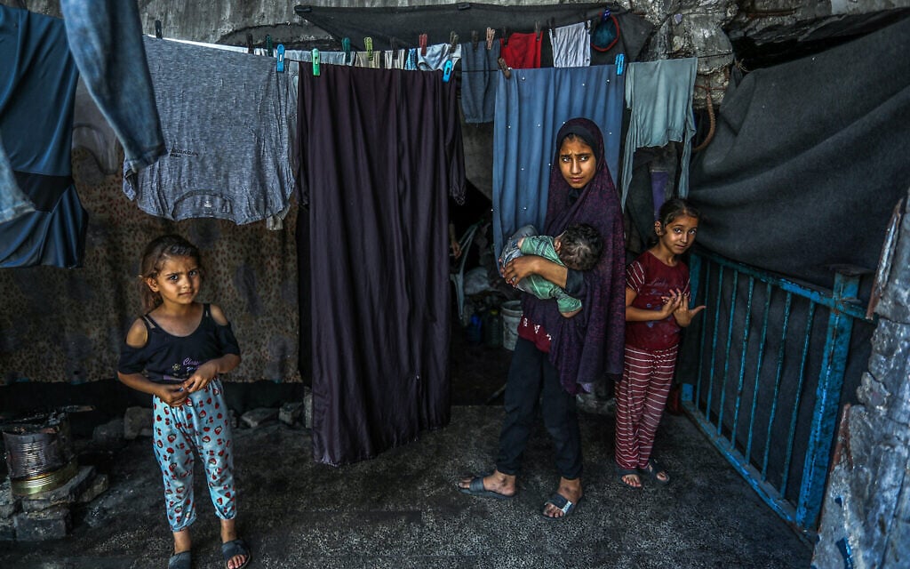 Palestinians who lost their homes in the Gaza war are seen near their tents in Khan Younis, in the southern Gaza Strip, June 28, 2026. (Abed Rahim Khatib/Flash90)