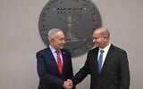 Prime Minister Benjamin Netanyahu, left, shakes hands with new Mossad chief Roman Gofman at a welcoming ceremony, June 2, 2026. (Haim Zach/GPO)