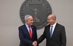 Prime Minister Benjamin Netanyahu, left, shakes hands with new Mossad chief Roman Gofman at a welcoming ceremony, June 2, 2026. (Haim Zach/GPO)