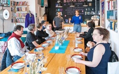 Participants in the Miszpucha Foundation trip for Polish Jewish emigrants and their descendants have lunch at the Jewish Community Center in Warsaw, Poland. (Adam de Kaminski via JTA)