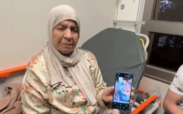 The grandmother of 7-month-old Sam Fahd Abou Haikal holds up a phone showing him, after he was killed by Israeli troops who fired on the car in which he and his parents were traveling in the West Bank on June 5, 2026. The IDF expressed 'deep sorrow' over the incident, saying troops in Hebron opened fire when they 'perceived a vehicle accelerating toward them'. It said an initial investigation had shown that 'those injured were uninvolved civilians'. (X screenshot)