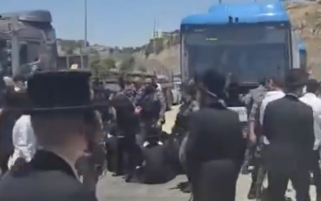 Haredi men block a bus at the Tunnels Checkpoint, between south Jerusalem and the West Bank, on June 7, 2026, following the arrest of a suspected participant in an anti-enlistment riot outside the home Supreme Court Justice Noam Sohlberg. (Screen capture: Moshe Zaide/ZiratNews via X)
