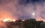 Fires blaze around the Palestinian town of Deir Dibwan following an arson attack by settlers targeting farmland and vehicles in the Ramallah area, on June 14, 2026. (Screenshot: X, used in accordance with Clause 27a of the Copyright Law)