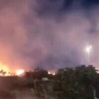 Fires blaze around the Palestinian town of Deir Dibwan following an arson attack by settlers targeting farmland and vehicles in the Ramallah area, on June 14, 2026. (Screenshot: X, used in accordance with Clause 27a of the Copyright Law)