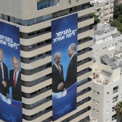 Prime Minister Benjamin Netanyahu is depicted shaking hands with US President Donald Trump, left, and Russian President Vladimir Putin, right, in election campaign posters that hang on the headquarters of Netanyahu's Likud party in central Tel Aviv, as seen in a video published on August 1, 2019. (Screen capture: Youtube/Benjamin Netanyahu) Prime Minister Benjamin Netanyahu is depicted shaking hands with US President Donald Trump, left, and Russian President Vladimir Putin, right, in election campaign posters that hang on the headquarters of Netanyahu's Likud party in central Tel Aviv, as seen in a video published on August 1, 2019. (Screen capture: Youtube/Benjamin Netanyahu)
