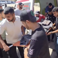 People carry the body of a Palestinian man reportedly killed in an Israeli airstrike west of Khan Younis in southern Gaza on June 21, 2026. (Screen capture: X/Palestine Today)