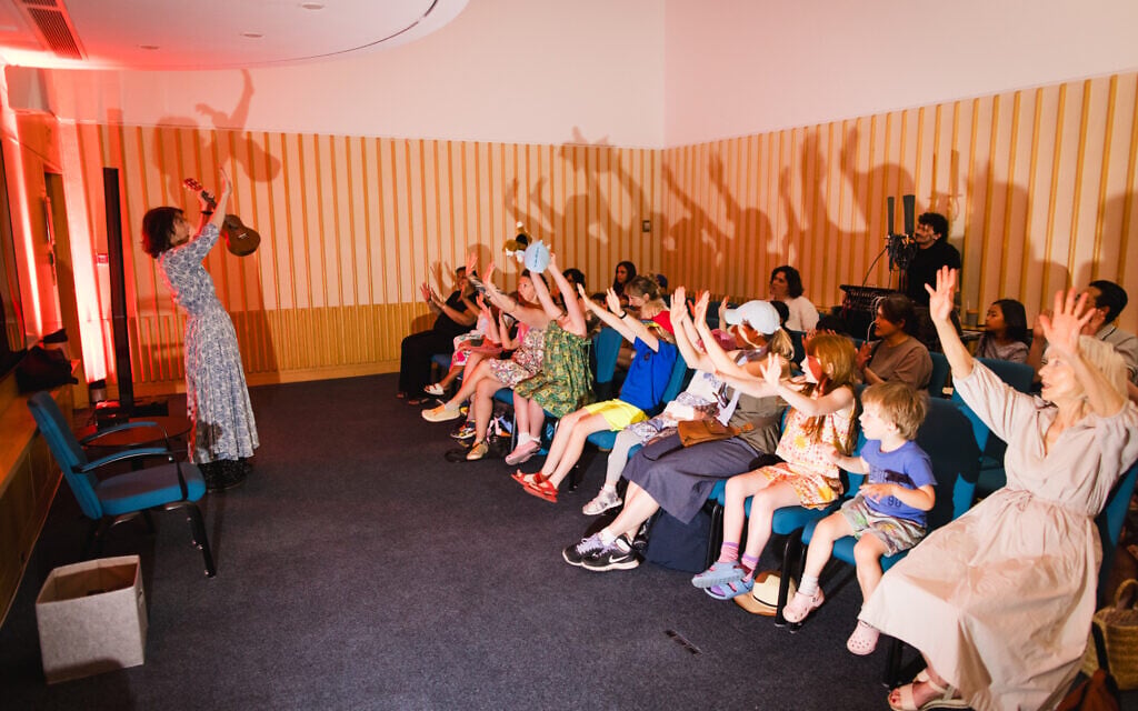 Young participants raise their hands at a program in the British Library for Jewish Culture Month, summer 2026. (Sophie Shaw)