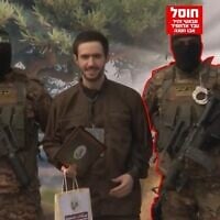 This image released by the IDF on June 22, 2026, shows Hamas terrorist Sabaei Zahir Abd al-Hamid Abu Hasna standing alongside hostage Omer Shem Tov upon the latter's release on February 22, 2025. (Israel Defense Forces)