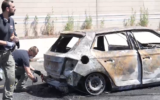 Police officers collect evidence at the scene of a car bombing that left a woman dead in Tel Aviv on June 4, 2026. (Screenshot/Israel Police)