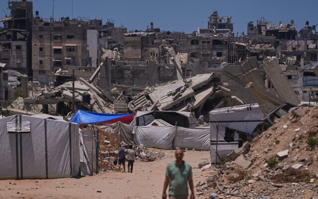 Palestinians walking along a street surrounded by destroyed buildings in Khan Younis, southern Gaza Strip, May 29, 2026. (Abdel Kareem Hana/AP) Palestinians walking along a street surrounded by destroyed buildings in Khan Younis, southern Gaza Strip, May 29, 2026. (Abdel Kareem Hana/AP)