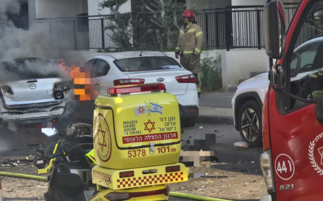 A car goes up in flames after it exploded, killing a man in his 40s in Jaffa on June 28, 2026. (Magen David Adom)