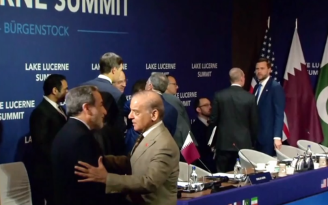 Footage from US-Iran talks in Switzerland shows Iranian Foreign Minister Abbas Araghchi (foreground, left) and US Vice President JD Vance (background, far right) in the same room together as delegations meet, June 21, 2026 (Video screenshot)