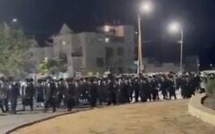 Haredi men protest the arrest of draft dodgers on June 5, 2026. Location of the video is unclear. (Screen grab used in accordance with Clause 27a of the Copyright Law)