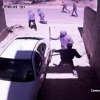 Settlers break the windows of a vehicle in the West Bank Palestinian town of Hawara, June 6, 2026. (Screen grab used in accordance with Clause 27a of the Copyright Law)