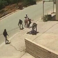 An IDF soldier, alongside settlers, beat two Palestinians in the West Bank town of Huwara, June 6, 2026. (X)