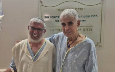Yonatan Rom, left, who donated his kidney to Reuven Tam, right, recover together following the transplant at Clalit-Beilinson Hospital on July 14, 2026. Reuven's brother, Eyal Tam, saved Rom's life in a terrorist attack on March 7, 2002. (Courtesy/Clalit-Beilinson Hospital) Yonatan Rom, left, who donated his kidney to Reuven Tam, right, recover together following the transplant at Clalit-Beilinson Hospital on July 14, 2026. Reuven's brother, Eyal Tam, saved Rom's life in a terrorist attack on March 7, 2002. (Courtesy/Clalit-Beilinson Hospital)