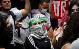 Anti-Zionist protesters wearing Hamas headbands outside Baruch College, in New York City, June 5, 2024. (Luke Tress/Times of Israel)