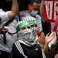 Anti-Zionist protesters wearing Hamas headbands outside Baruch College, in New York City, June 5, 2024. (Luke Tress/Times of Israel)