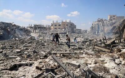Palestinians inspect a site of an Israeli strike on a storage facility that was warned by the Israeli military to evacuate earlier before it was struck, in Gaza City, July 27, 2026. (Ebrahim Hajjaj/Reuters)