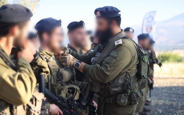 Cadets of the Hasmonean Brigade for ultra-Orthodox troops receive their platoon commander pins following a march in the Golan Heights, June 1, 2026. (Israel Defense Forces) Cadets of the Hasmonean Brigade for ultra-Orthodox troops receive their platoon commander pins following a march in the Golan Heights, June 1, 2026. (Israel Defense Forces)