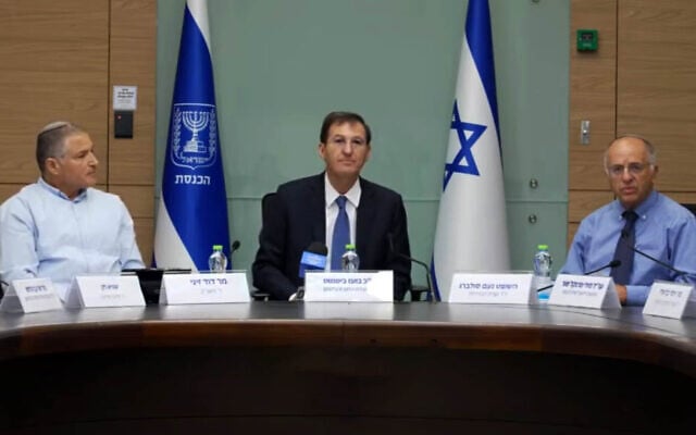 From left: Shin Bet head David Zini, Likud MK and Knesset Foreign Affairs and Defense Committee Chairman Boaz Bismuth, Central Elections Committee chair and Deputy Supreme Court President Noam Sohlberg, July 27, 2026. (Kan screenshot via YouTube)