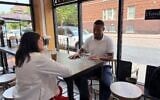 US Rep. Haley Stevens (l), candidate for the Democratic Senate nomination in Michigan, discusses Israel with Jai Singletary, director of a Detroit neighborhood improvement association, in Detroit, Michigan, July 27, 2026. (Andrew Lapin/JTA)