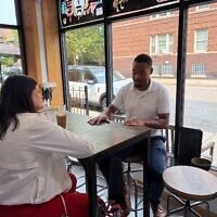 US Rep. Haley Stevens (l), candidate for the Democratic Senate nomination in Michigan, discusses Israel with Jai Singletary, director of a Detroit neighborhood improvement association, in Detroit, Michigan, July 27, 2026. (Andrew Lapin/JTA)