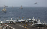 US Navy warships and aircraft transit the Arabian Sea in close formation, in a photo released July 8, 2026. (US Navy photo)