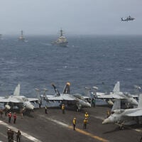 US Navy warships and aircraft transit the Arabian Sea in close formation, in a photo released July 8, 2026. (US Navy photo)