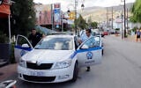 Illustrative: Policemen enter their vehicle on July 23, 2013, in Malia on the Greek island of Crete. (AFP/Costas Metaxakis)