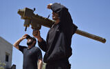 Illustrative: Rebel-fighters monitor the sky holding a FN-6 man-portable air-defence system (MANPADS) in the Syrian village of Teir Maalah, on the northern outskirts of Homs, on April 20, 2016. (MAHMOUD TAHA/AFP)