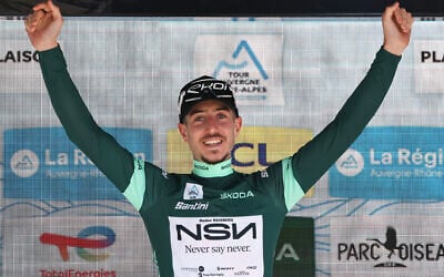 NSN Cycling Team's Israeli rider Nadav Raisberg celebrates on the podium with the sprinter's green jersey after the 8th and final stage of the Tour Auvergne-Rhone-Alpes cycling race in the French Alps on June 14, 2026. (Anne-Christine POUJOULAT / AFP)