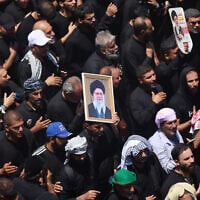 Shiite Muslim pilgrims hold pictures of Iran's slain supreme leader Ayatollah Ali Khamenei while taking part in Ashura in Iraq's holy city of Karbala on June 26, 2026. (AHMAD AL-RUBAYE / AFP)