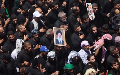 Shiite Muslim pilgrims hold pictures of Iran's slain supreme leader Ayatollah Ali Khamenei while taking part in Ashura in Iraq's holy city of Karbala on June 26, 2026. (AHMAD AL-RUBAYE / AFP) Shiite Muslim pilgrims hold pictures of Iran's slain supreme leader Ayatollah Ali Khamenei while taking part in Ashura in Iraq's holy city of Karbala on June 26, 2026. (AHMAD AL-RUBAYE / AFP)