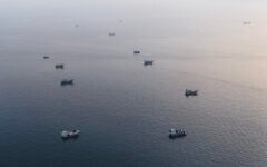 This aerial photograph shows boats anchored off Omans northern Musandam Peninsula near the Strait of Hormuz on June 27, 2026. (AFP)
