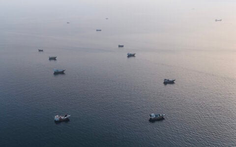 This aerial photograph shows boats anchored off Omans northern Musandam Peninsula near the Strait of Hormuz on June 27, 2026. (AFP)