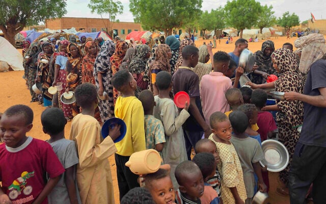 Women and children queue to receive free food being distributed in al-Mohayra camp for displaced people, near the city of El-Obeid in the southern Kordofan region, on June 29, 2026. (AFP) Women and children queue to receive free food being distributed in al-Mohayra camp for displaced people, near the city of El-Obeid in the southern Kordofan region, on June 29, 2026. (AFP)