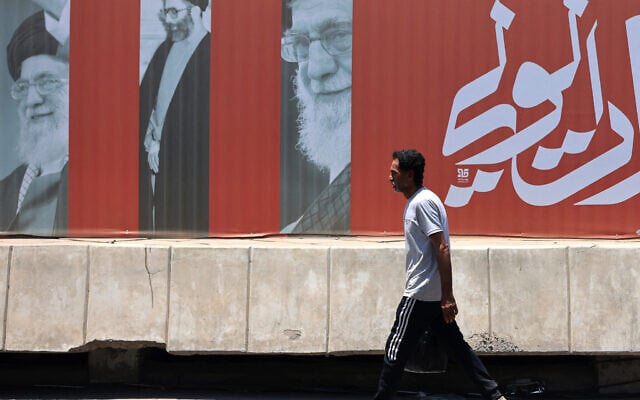 A commuter walks past a billboard bearing pictures of Iran's late supreme leader Ayatollah Ali Khamenei, along a street in Baghdad on July 2, 2026, ahead of his funeral in Tehran. (AHMAD AL-RUBAYE / AFP) A commuter walks past a billboard bearing pictures of Iran's late supreme leader Ayatollah Ali Khamenei, along a street in Baghdad on July 2, 2026, ahead of his funeral in Tehran. (AHMAD AL-RUBAYE / AFP)
