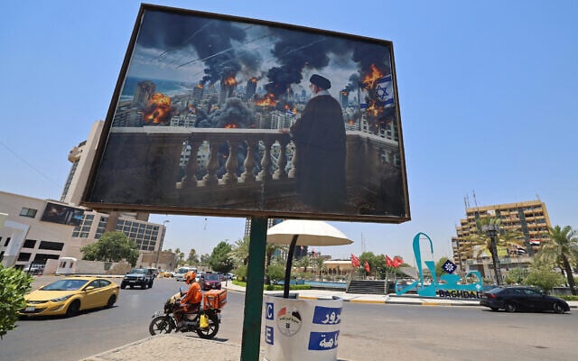 Motorists drive past a giant billboard bearing a picture of Iran's late supreme leader Ayatollah Ali Khamenei, along a road junction in Baghdad on July 2, 2026, ahead of his funeral in Tehran (AHMAD AL-RUBAYE / AFP)
